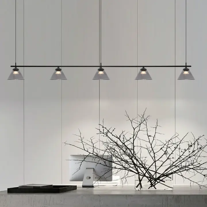Ada pendants in a row above a minimalist console