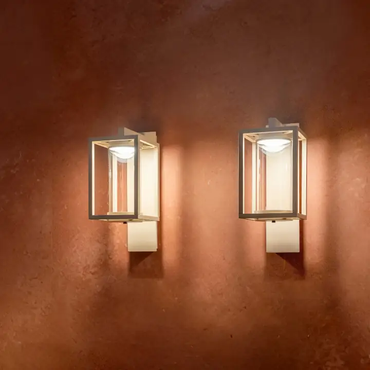 Pair of Amos lantern sconces on a rendered wall