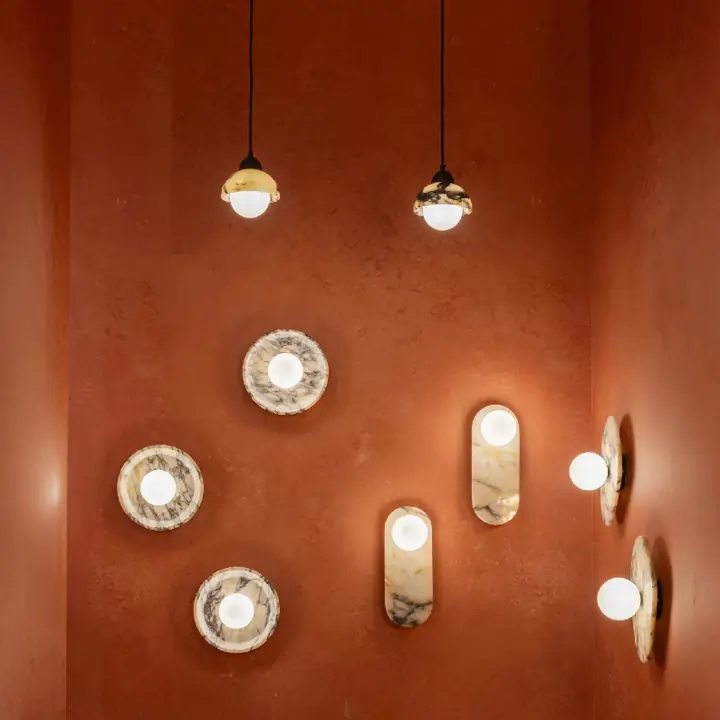 Bulgari marble wall lights and pendants arranged on a wall