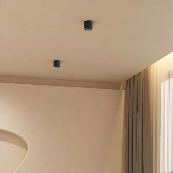 Carlo surface downlights on a ceiling above a curved sofa