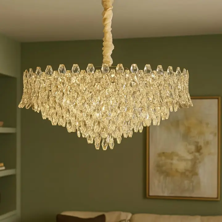Ivory crystal chandelier over a green-walled dining room