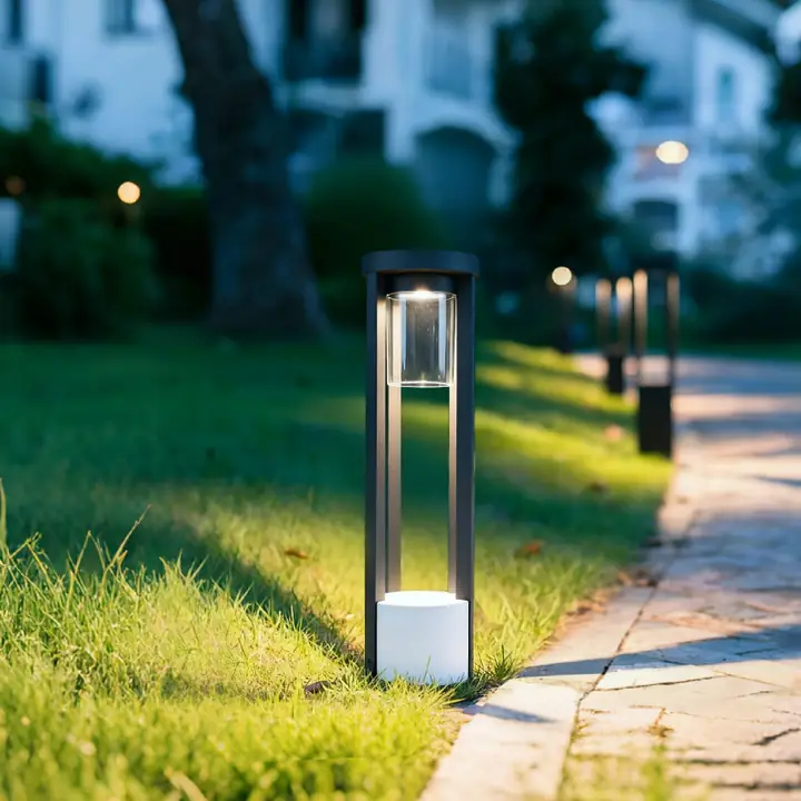 Plura bollards lining a lawn edge at twilight