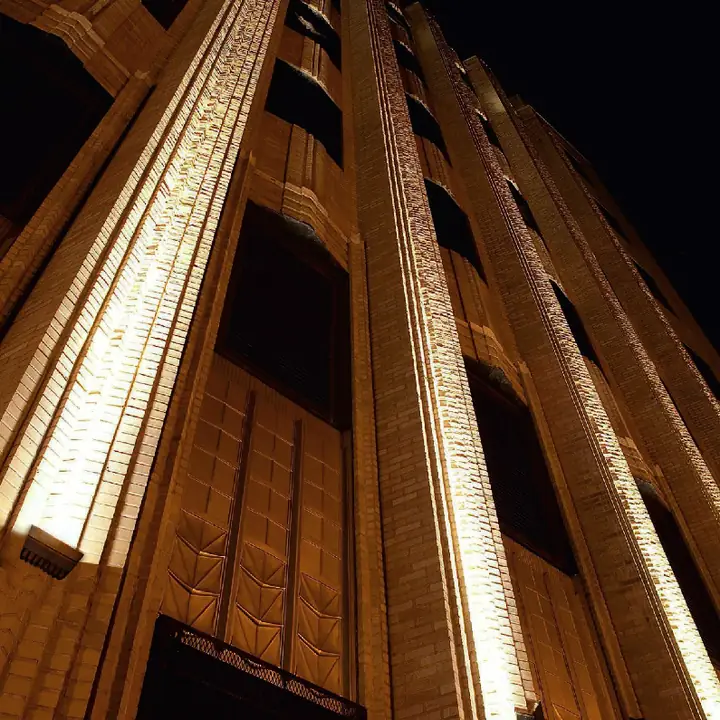 Slopia floodlights throwing light up a tall building facade