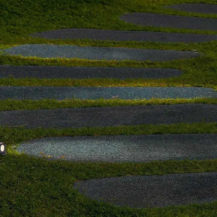 Stenos in-ground lights washing stepping stones set in grass