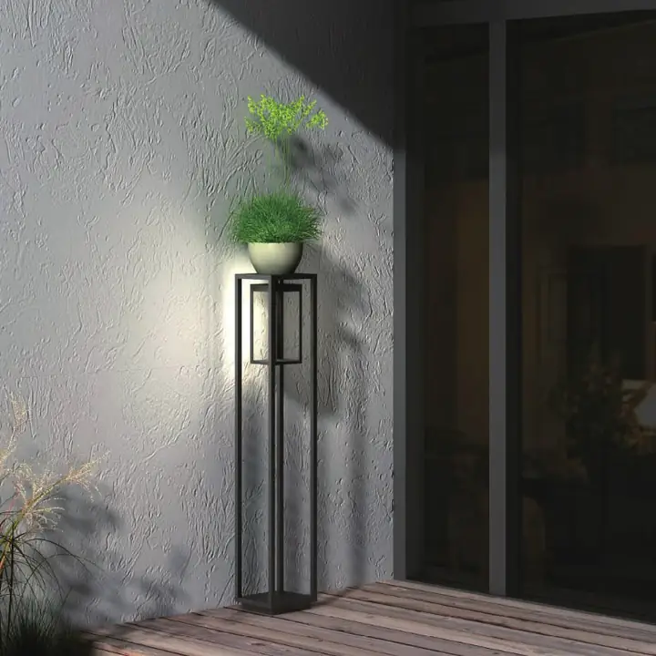 Tower bollard glowing beside a rendered wall