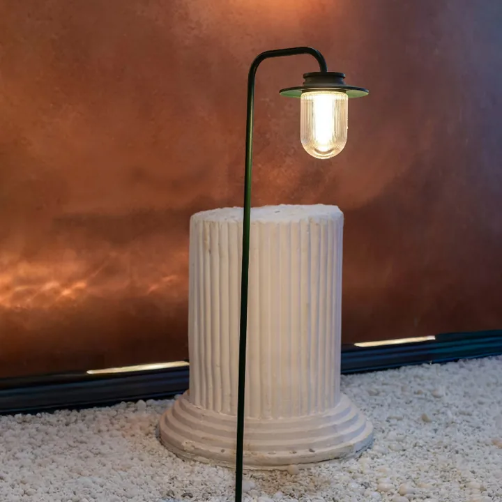 Tron bollard lighting a fluted stone column on pale gravel