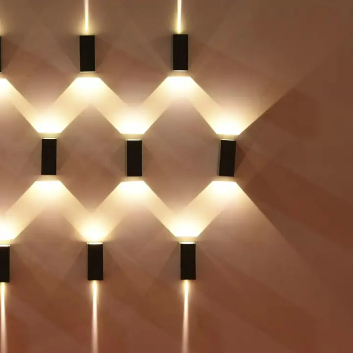 Grid of Zono wall lights casting crossed beams